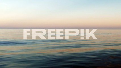 a calm day on the ocean with no waves and blue sky