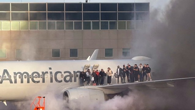 Watch: American Airlines plane bursts into flames as passengers escape on wing