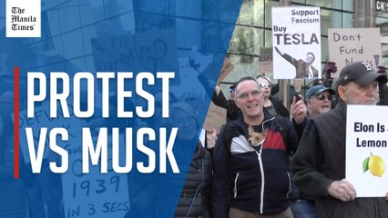 Protesters gather outside Tesla dealership in Boston to oppose Elon Musk