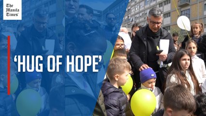 Children bring a ‘Hug of Hope’ to Pope Francis outside Gemelli hospital