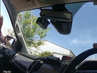 WATCH: Video footage appears to show Eric Lord's wife grabbing onto the policeman's vehicle as he drove forward.