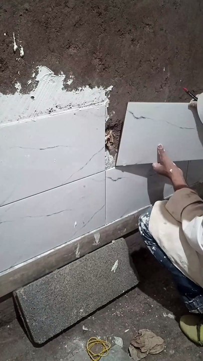 Professional cutting and installing ceramic tiles around electrical switches! #tiles #ceramic