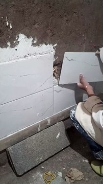 Professional cutting and installing ceramic tiles around electrical switches! #tiles #ceramic