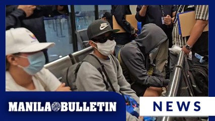 30 OFWs rescued from online human trafficking scam arrive at NAIA