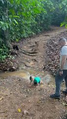 Boy Falls While Running Through Small Creek