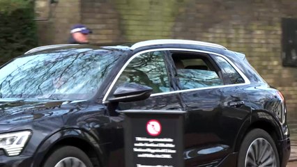 The King waves to well-wishers following hospital visit