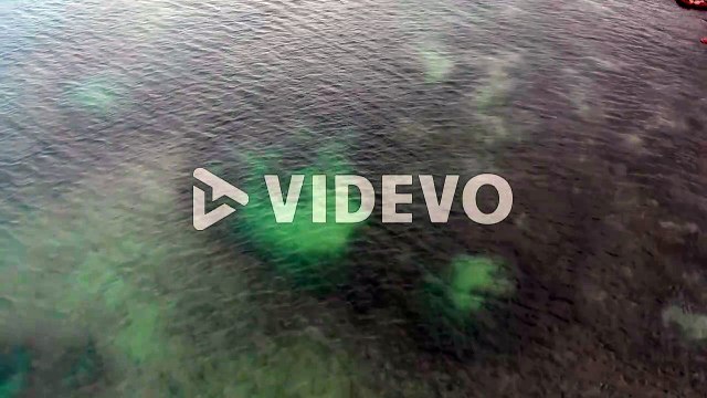 Aerial drone view of the deserted empty rocky beach and cliffs in Lagos, Algarve, Portugal