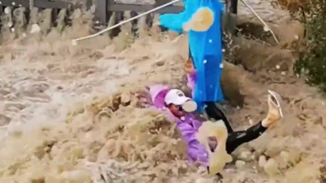 Massive Flutwelle schwappt über das Flussufer - und wirft Touristen um