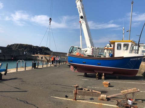 Summer is on its way: Crowds watch iconic Portstewart boats get airlifted into the harbour
