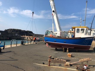 Summer is on its way: Crowds watch iconic Portstewart boats get airlifted into the harbour