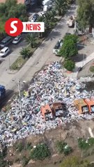 Piles of garbage fill streets of central Bolivia as residents protest dumpster