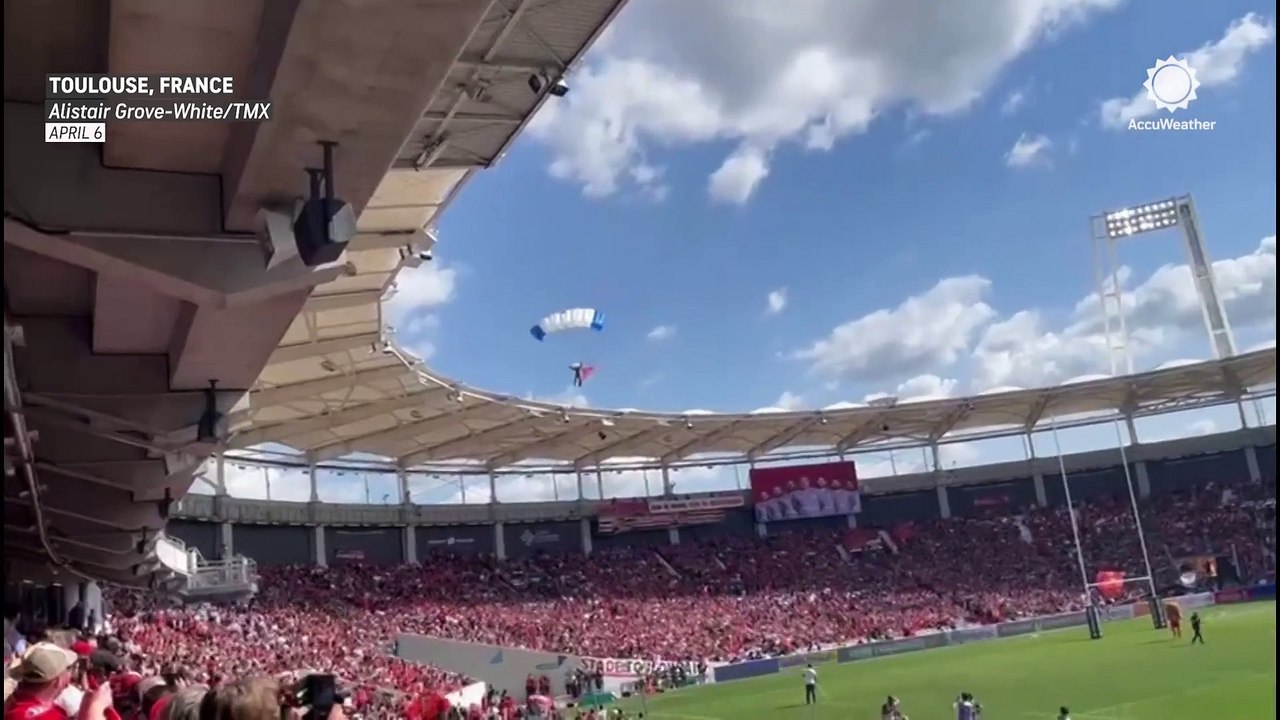 French parachutist caught and dangling from stadium roof