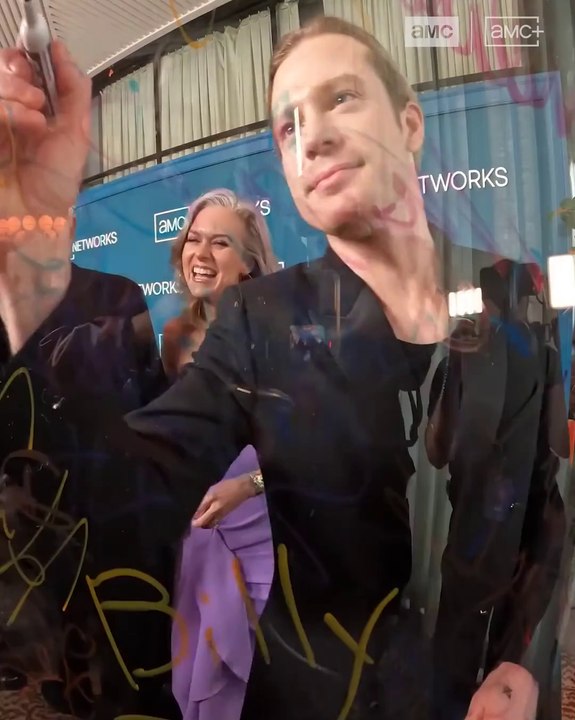 Sam Reid, Nicholas Denton & Eric Bogosian Sign an Autograph Glass on the Black Carpet at the 2025 AMC Upfront Event for the Immortal Universe