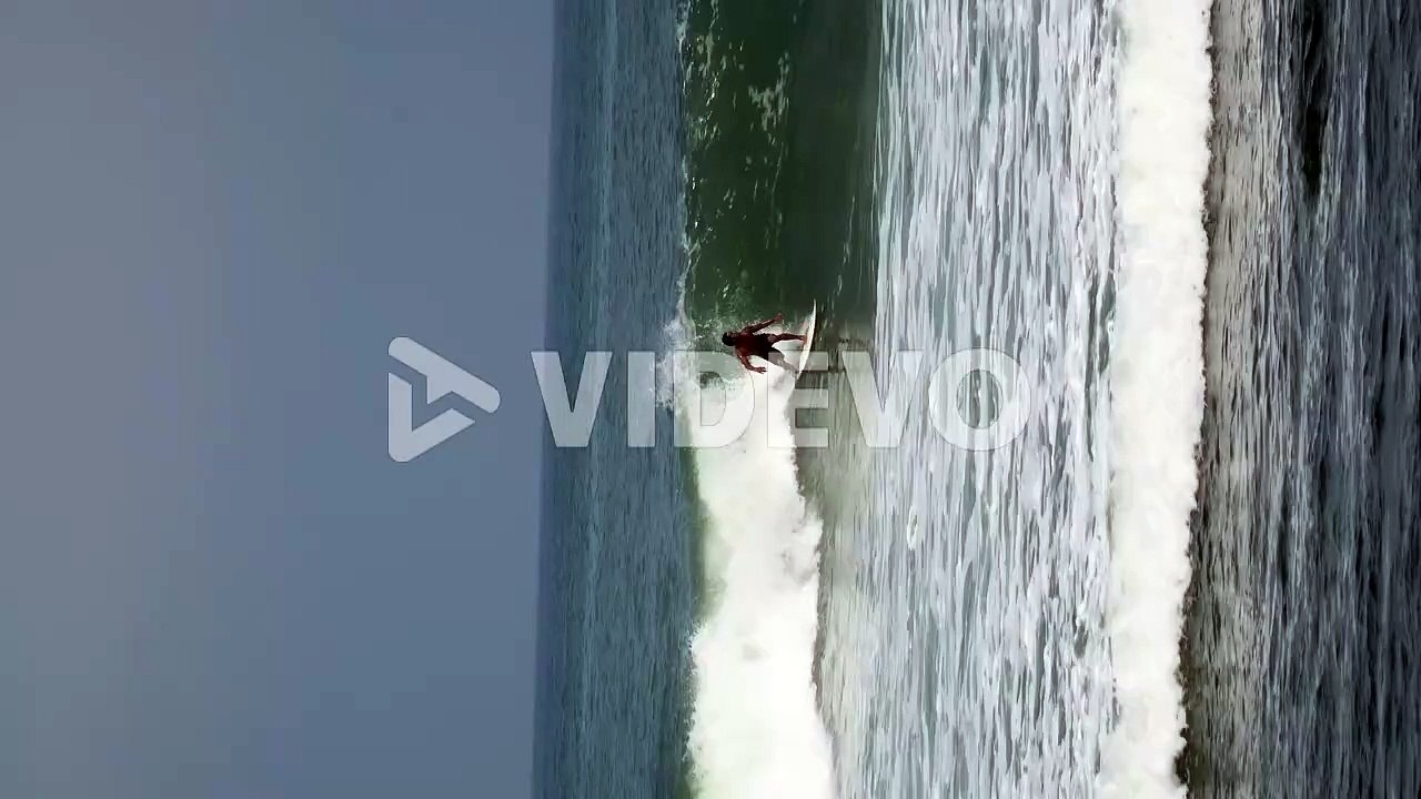 Vertical video surfer surfing on ocean wave Zoom