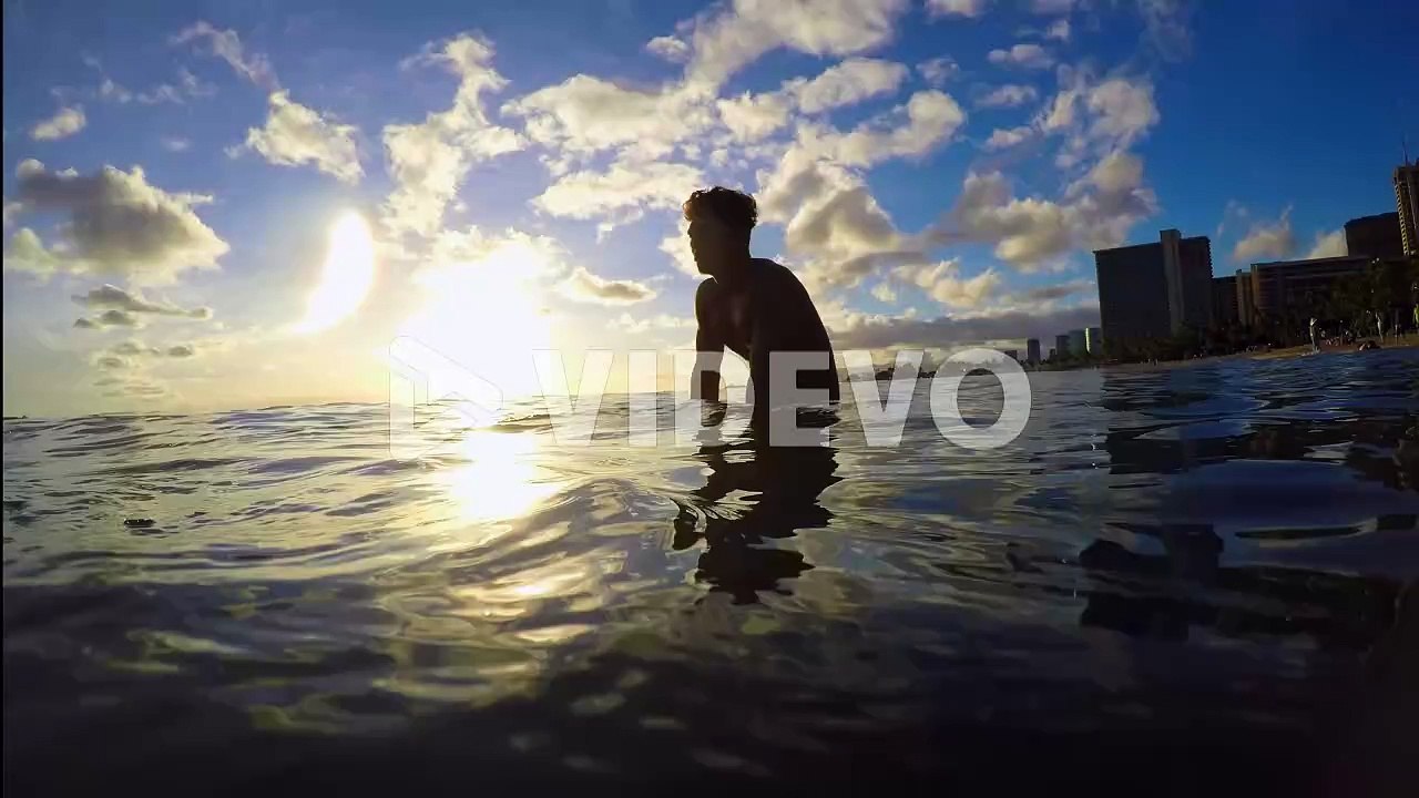 Surfer with surfboard surfing in sea water 4k