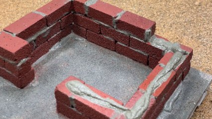 Artist brings a miniature house to life with tiny bricks, window, and front door