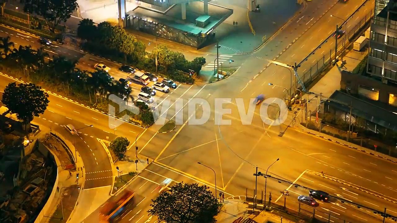 Singapore, Singapore - Circa August 2016 Time-lapse of evening traffic moving through a busy intersection in Singapore