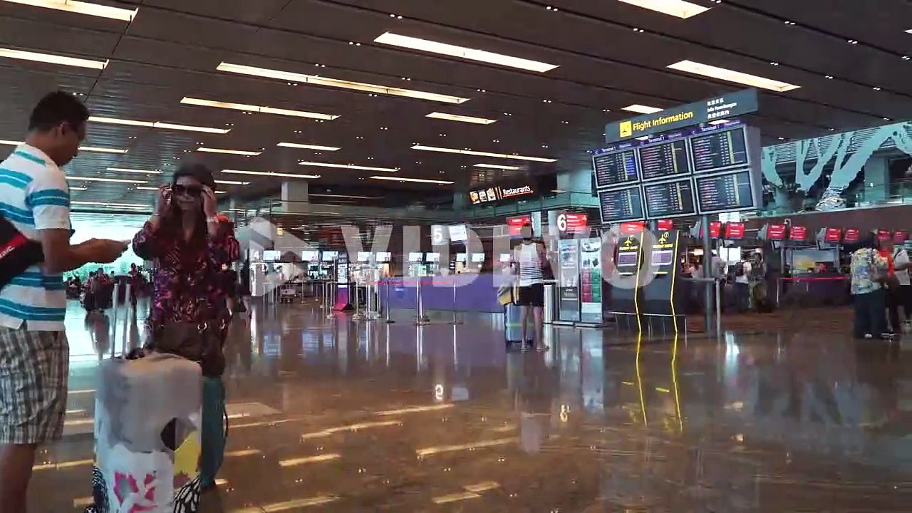 Singapore - Circa Time lapse of busy travelers at Singapore airport