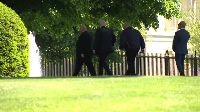 Trump surveys White House grounds for a location of planned flag poles