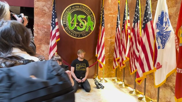 Extinction Rebellion protester defaces Trump Tower presidential plaque with bright green paint