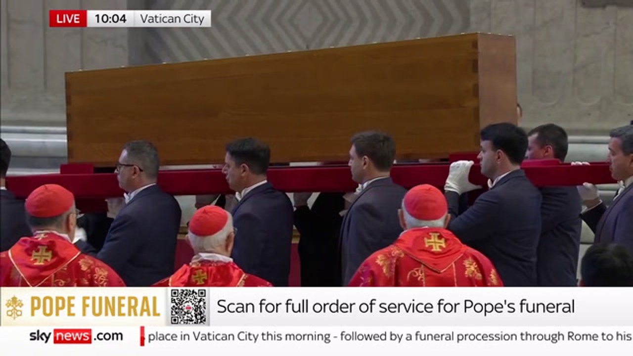 Pallbearers carry Pope Francis’s coffin through St. Peter’s Basilica as the funeral service begins.