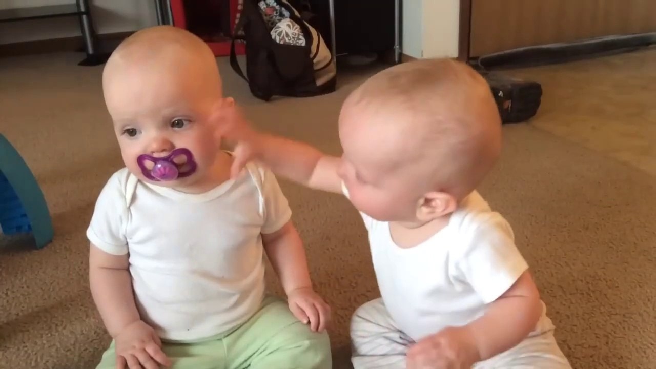 Twins baby girls fight over Pacifier