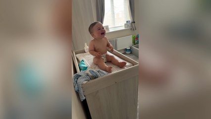 Adorable moment baby can't stop laughing at dad's bedtime tricks