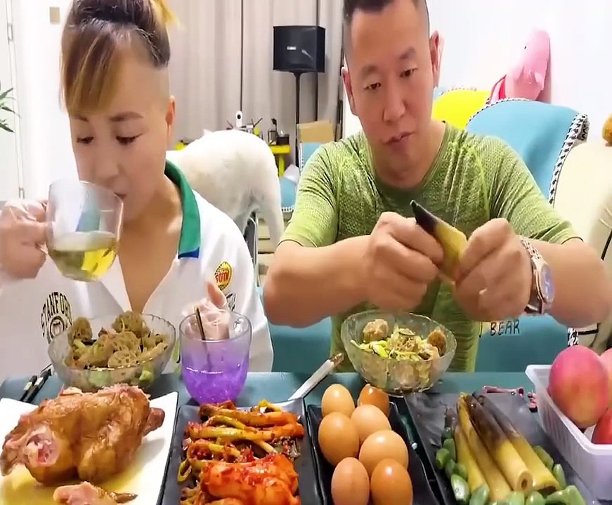 A young couple eating their food funny way