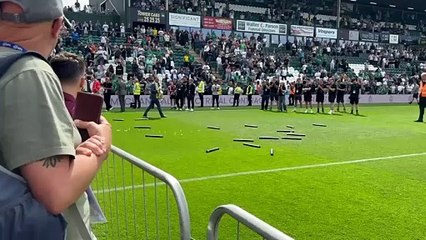 Paraag Marathe carries the Championship trophy onto the pitch