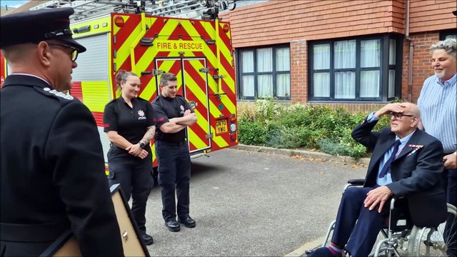 Former Worthing firefighter Patrick Bushby is presented with a framed letter of congratulations to mark his 100th birthday
