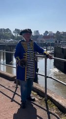 Watchet Town Crier Dave Milton marks the return to automatic working of the town marina's gate.