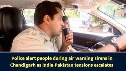 Police alert people during air warning sirens in Chandigarh as India-Pakistan tensions escalates