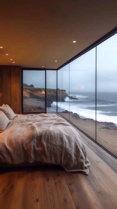 Oceanfront Serenity, Modern Luxury Bedroom with Floor-to-Ceiling Windows Overlooking Dramatic Coastal Waves and Rocky Shoreline Scenic View.#reel#reelinstagram#reelfacebook#fyp#foryou#cozychic#bedroomoasis#peacefulretreat#follow