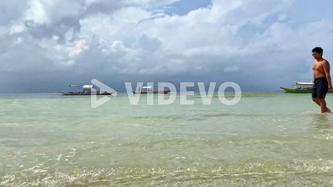 Young Tourist Admiring Tropical Beach Filled with Bangka Boats - Philippines Travel and Destinations