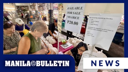 People queue to buy P20-per-kilo rice at Pasay Public Market