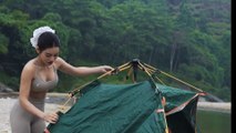 Pretty girl camping alone by the stream