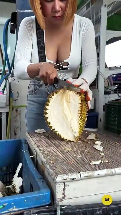 Beautiful girl cutting durian