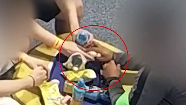 CCTV from HMP Peterborough shows man handing inmate package