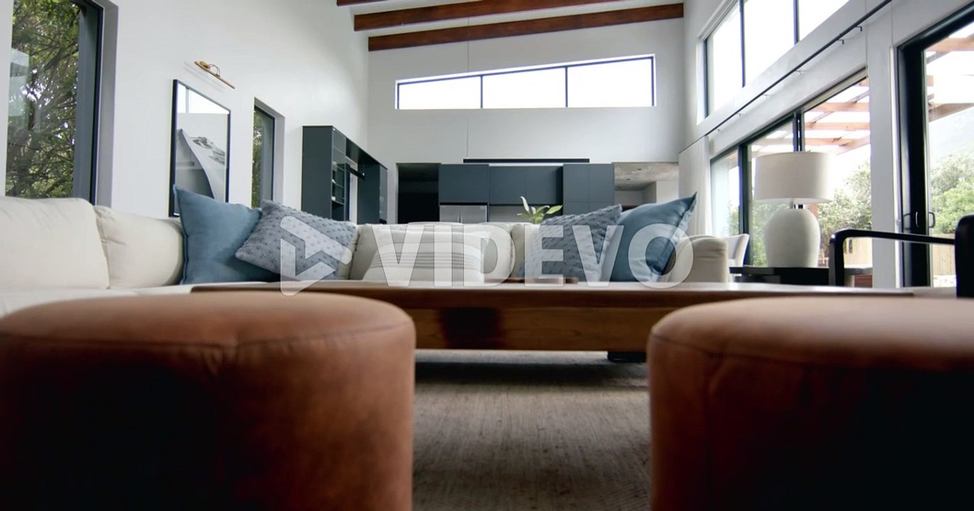 Interior of bright open plan living room, dining room and kitchen, copy space, slow motion