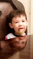 Kid Has Fun Time Licking Lollipop While Sitting at Table