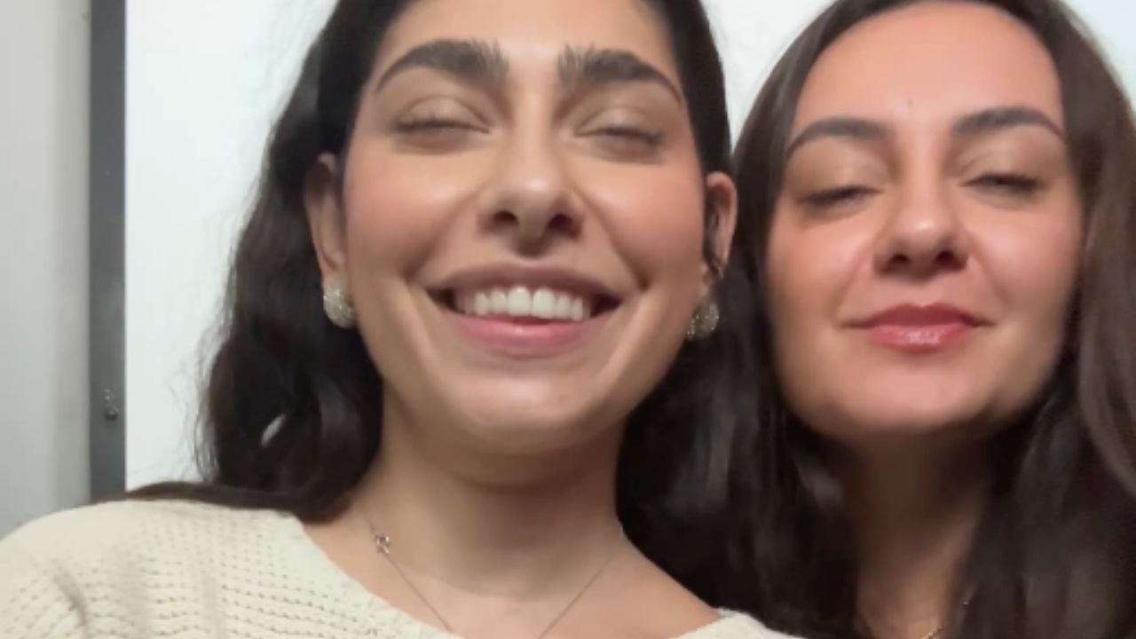 Joyous reaction as woman finds out about friend's pregnancy during photo booth session