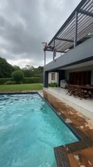 Guy Backflips From Balcony And Nearly Misses Pool's Edge