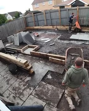 Worker Slips and Faceplants While Moving Concrete Wheelbarrow Up Ramp