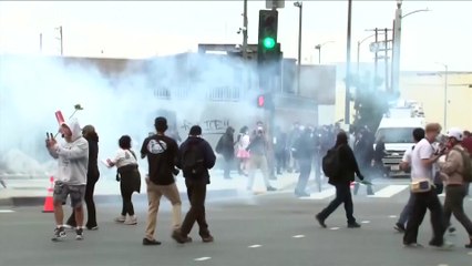 Tear gas fills LA streets as protesters clash with police following ICE raids