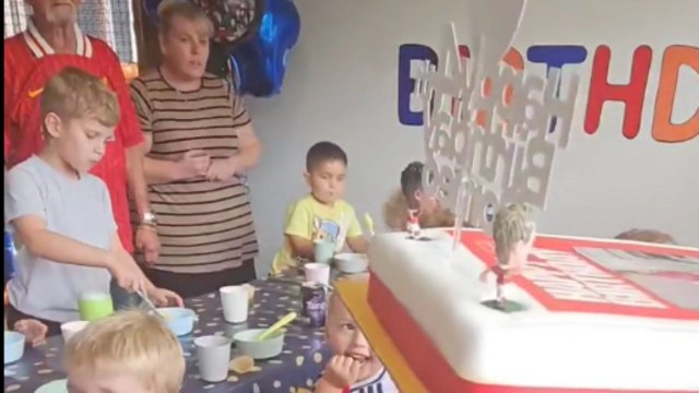 Comical birthday moment as lad falls off bench before blowing out cake candles