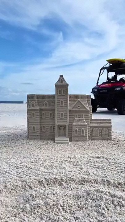 Incredible sand sculpture meets its classic beach fate.