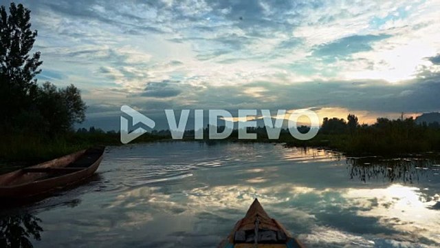 Tranquility Of Calm Lake With Fishing Boats During Sunset