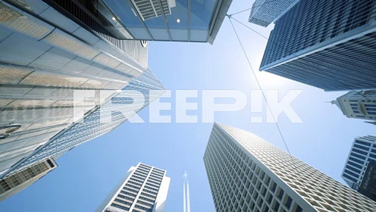 looking up view of city skyline buildings with aircraft