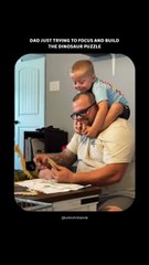 Dad just trying to focus and build the dinosaur puzzle.