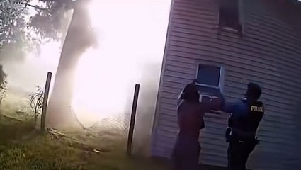 Heart-stopping moment police catch child jumping from window of burning house